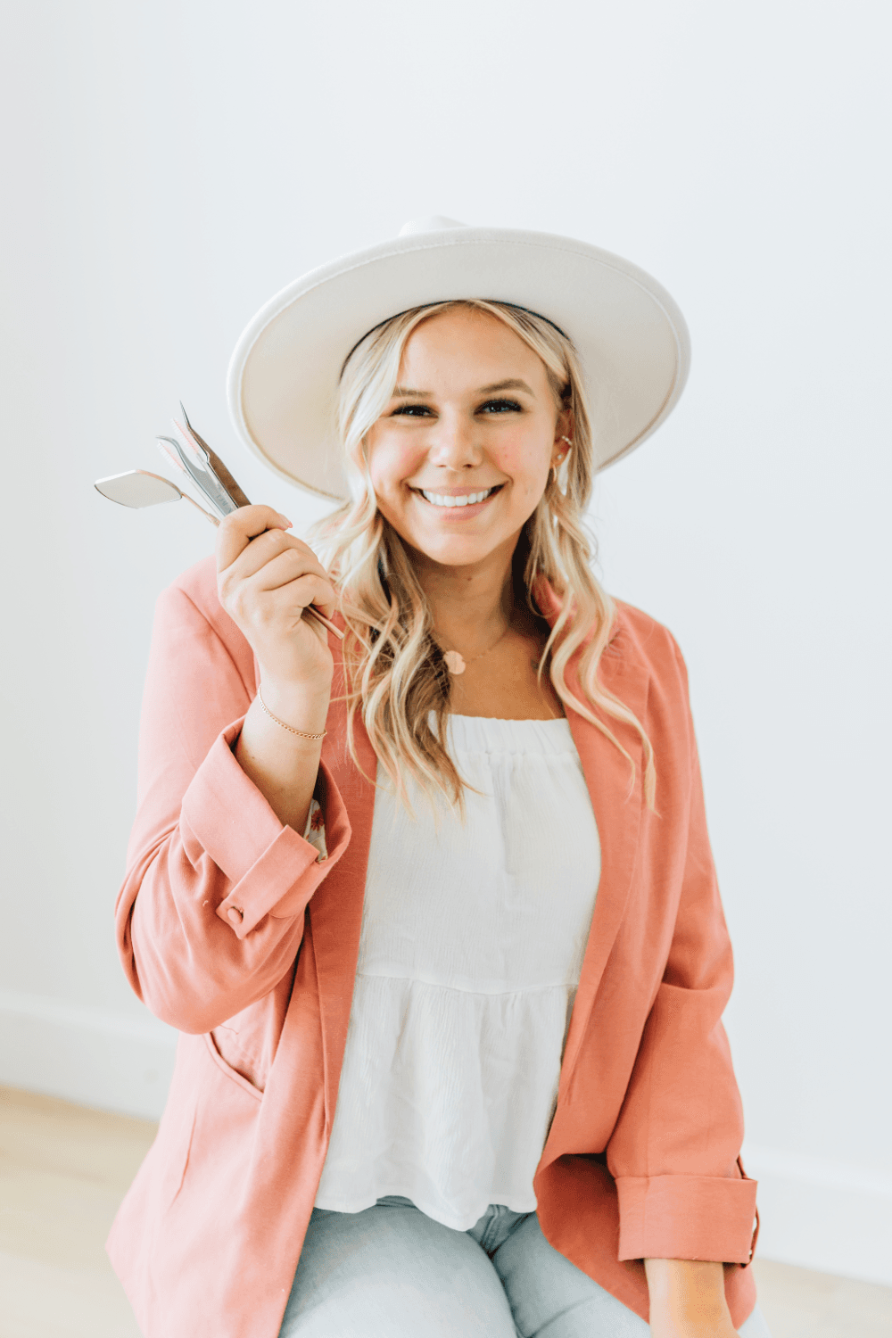 Lexi stands posing with her lash extensions and aesthetics equipment. She performs natural lash extensions and is a lash artist $in $American Fork, UT.