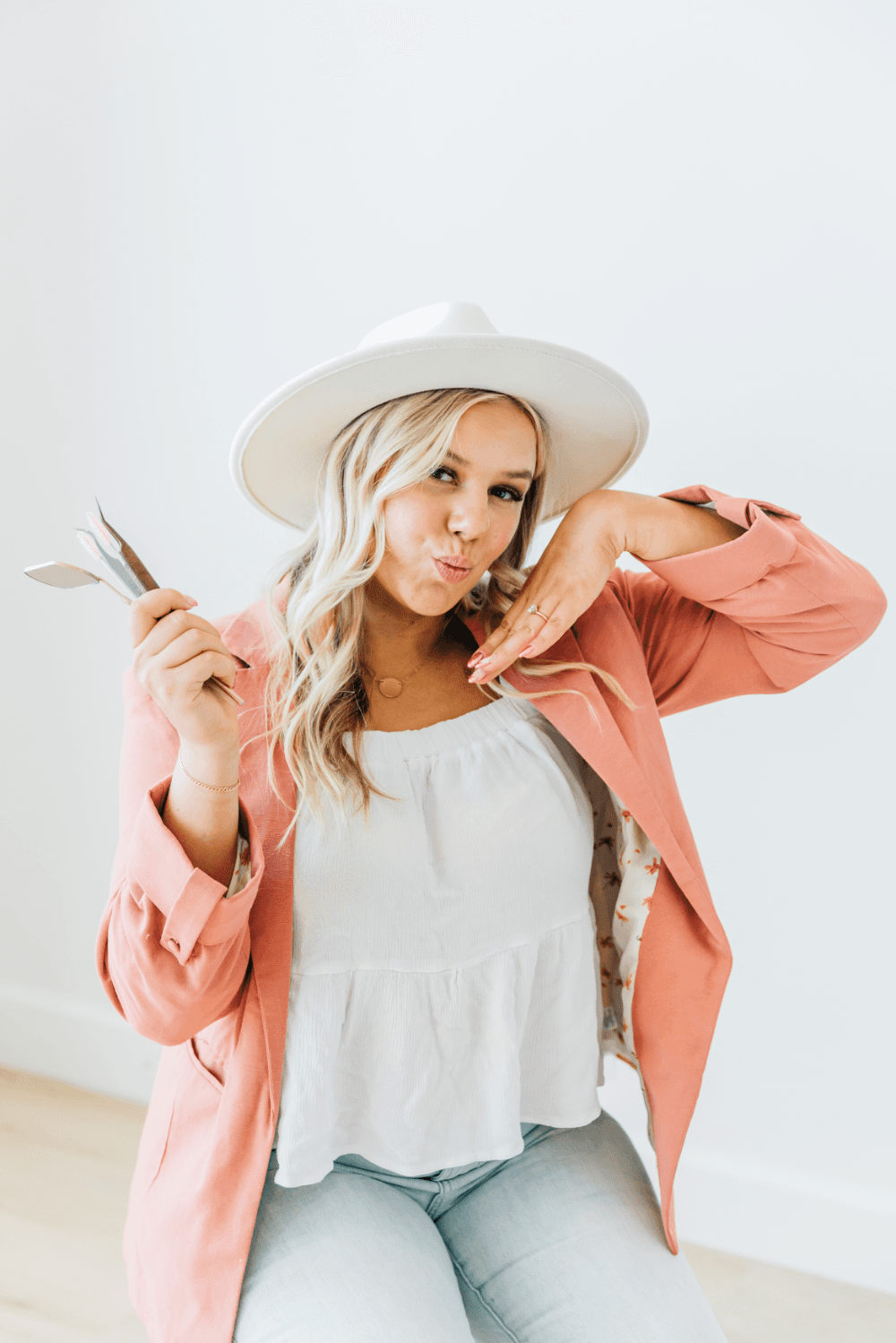 Lex poses with some of her spray tan equipment. Spray tans performed by Lexi, a spray tan specialist with open spray tan appointments in American Fork, UT.