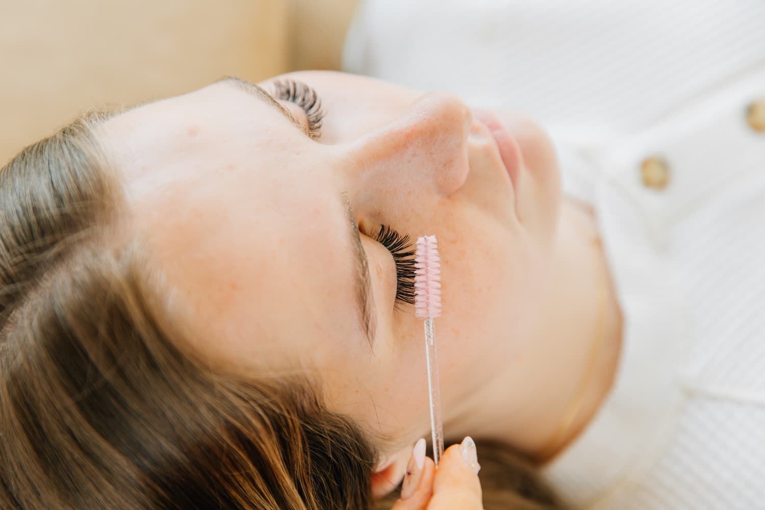 Lexi stands posing with her lash extensions and aesthetics equipment. She performs natural lash extensions and is a lash artist $in $American Fork, UT.